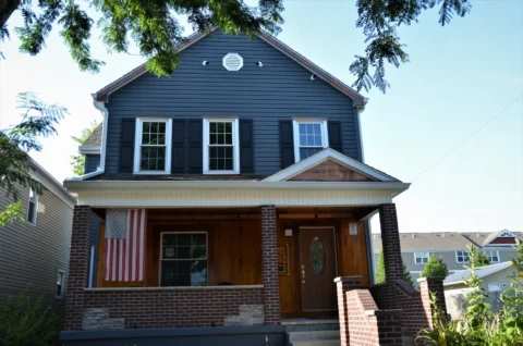 A home in Tacoma with an American flag hanging from the porch.